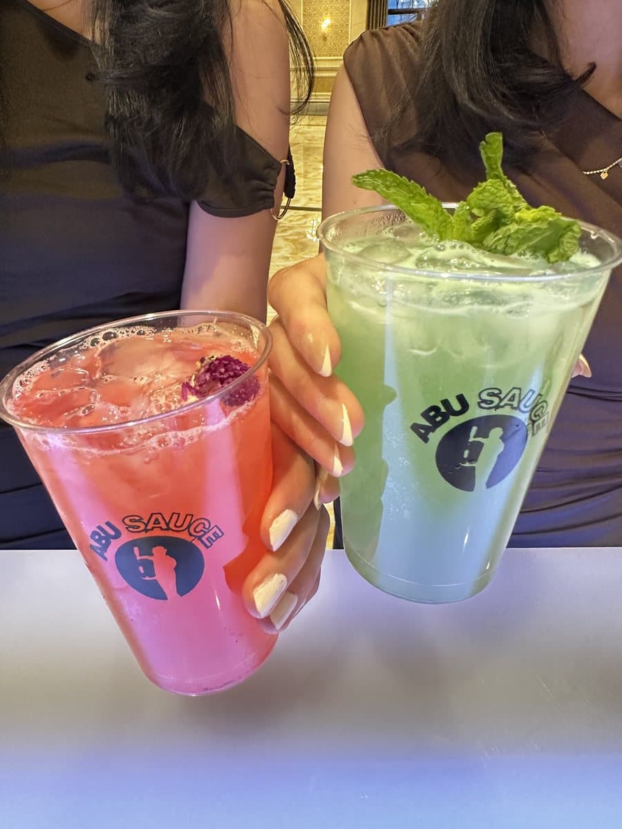 Guests toasting with Abu Sauce mocktails at an event near Naperville, IL