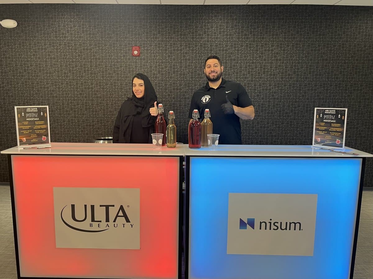The Abu Sauce bar branded with Ulta Beauty and Nisum logos at a corporate event