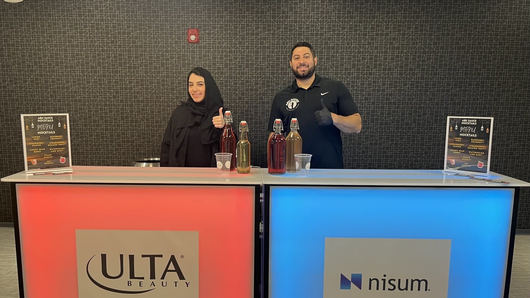 The Abu Sauce bar branded with Ulta Beauty and Nisum logos, two staff behind it